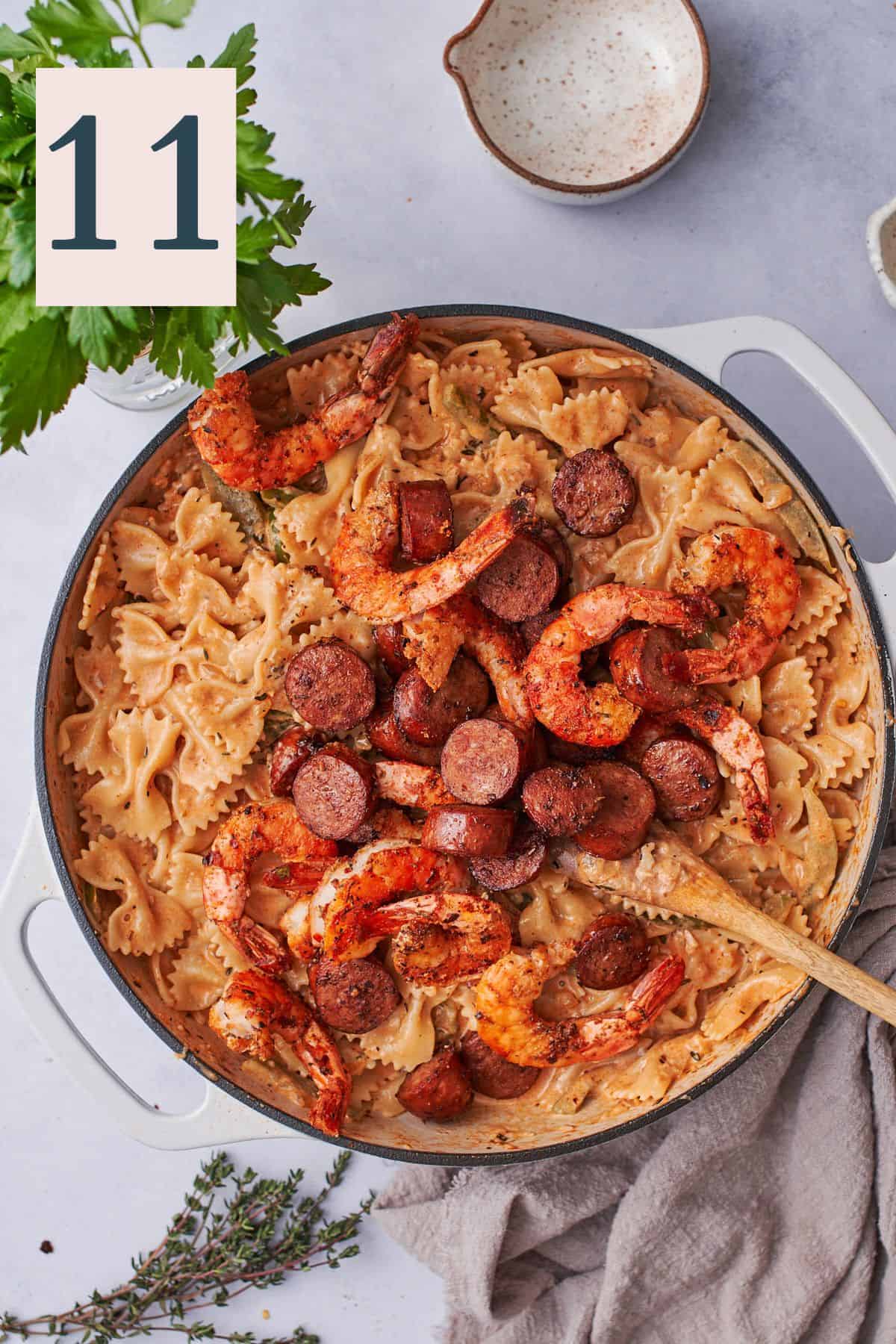 cooked sausage and shrimp added to pasta.